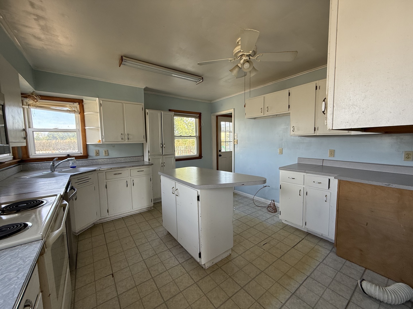 403 South Kennedy Drive Georgetown, IL 61846 - Photo 3 of 9 a kitchen with granite countertop cabinets stainless steel appliances a sink and a window