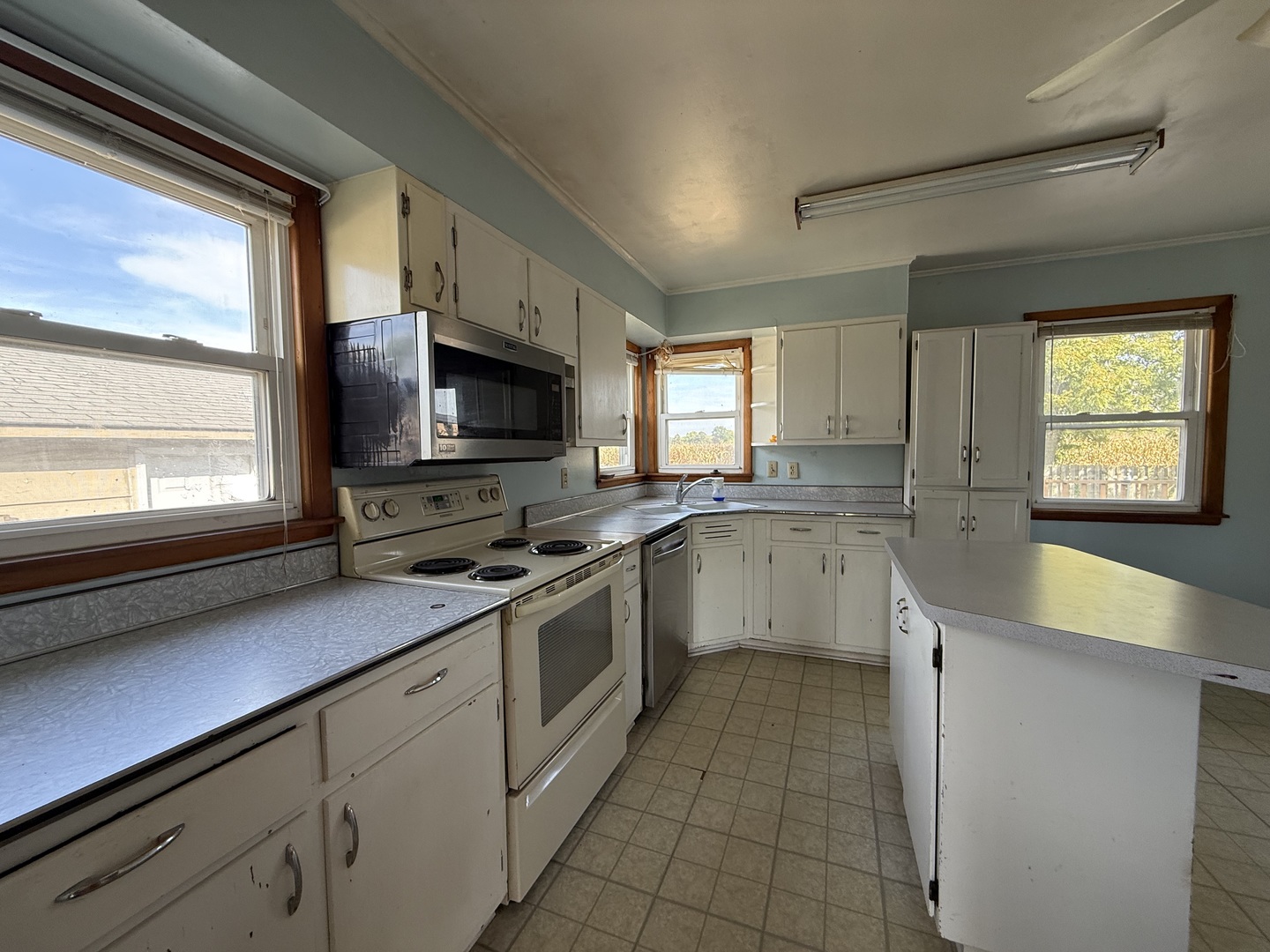 403 South Kennedy Drive Georgetown, IL 61846 - Photo 4 of 9 a kitchen with a sink stove top oven and cabinets