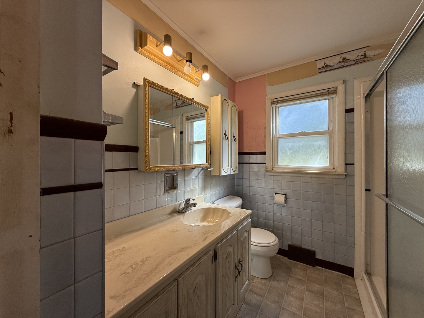 403 South Kennedy Drive Georgetown, IL 61846 - Photo 6 of 9 a bathroom with a granite countertop sink toilet and shower