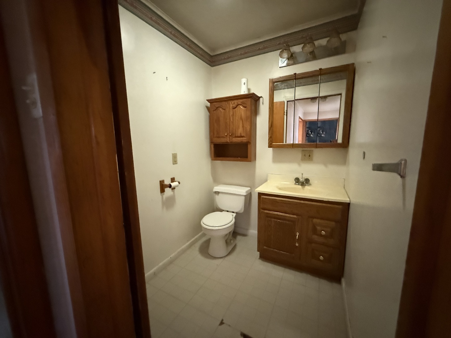 403 South Kennedy Drive Georgetown, IL 61846 - Photo 7 of 9 a bathroom with a toilet a sink and a mirror