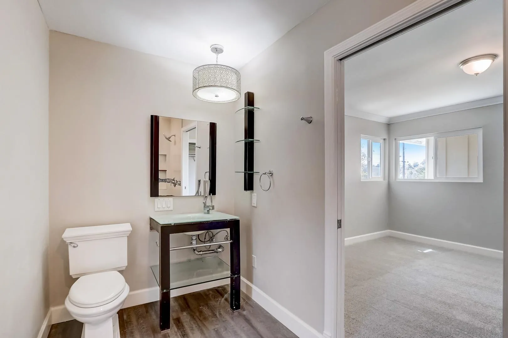 220 Shetland Way Fallbrook, CA 92028 - Photo 8 of 24 a bathroom with a toilet a sink and mirror