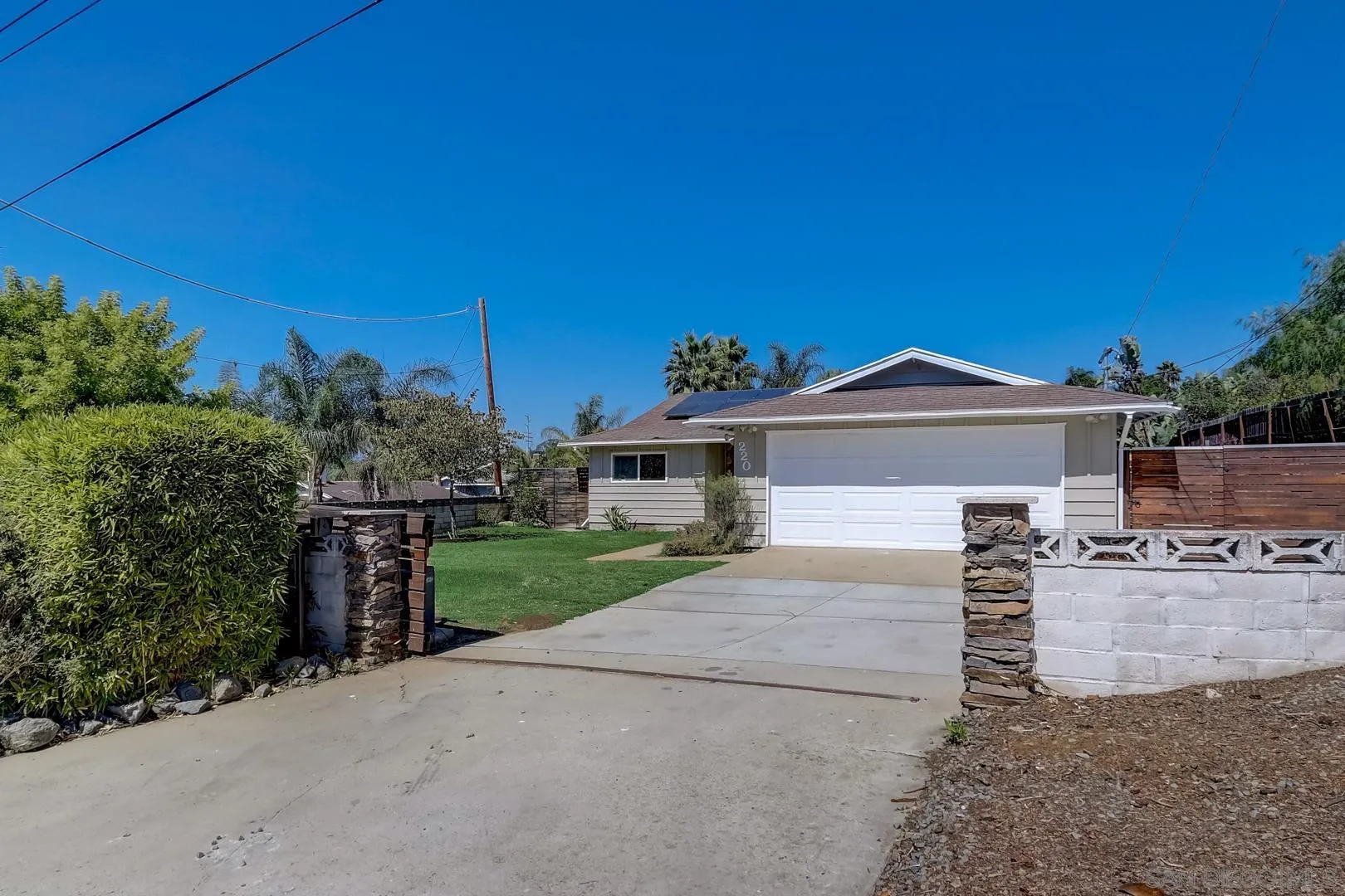 220 Shetland Way Fallbrook, CA 92028 - Photo 10 of 24 a view of a house with a yard and table and chairs under an umbrella