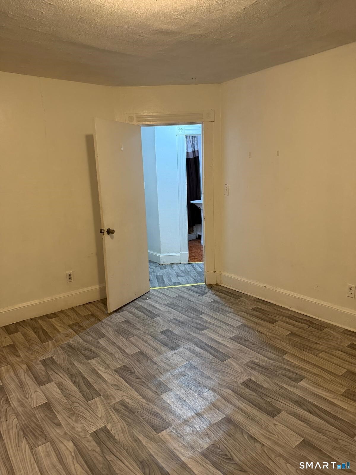 27 Connerton Street New Britain, CT 06051 - Photo 15 of 22 a view of an empty room with wooden floor and closet