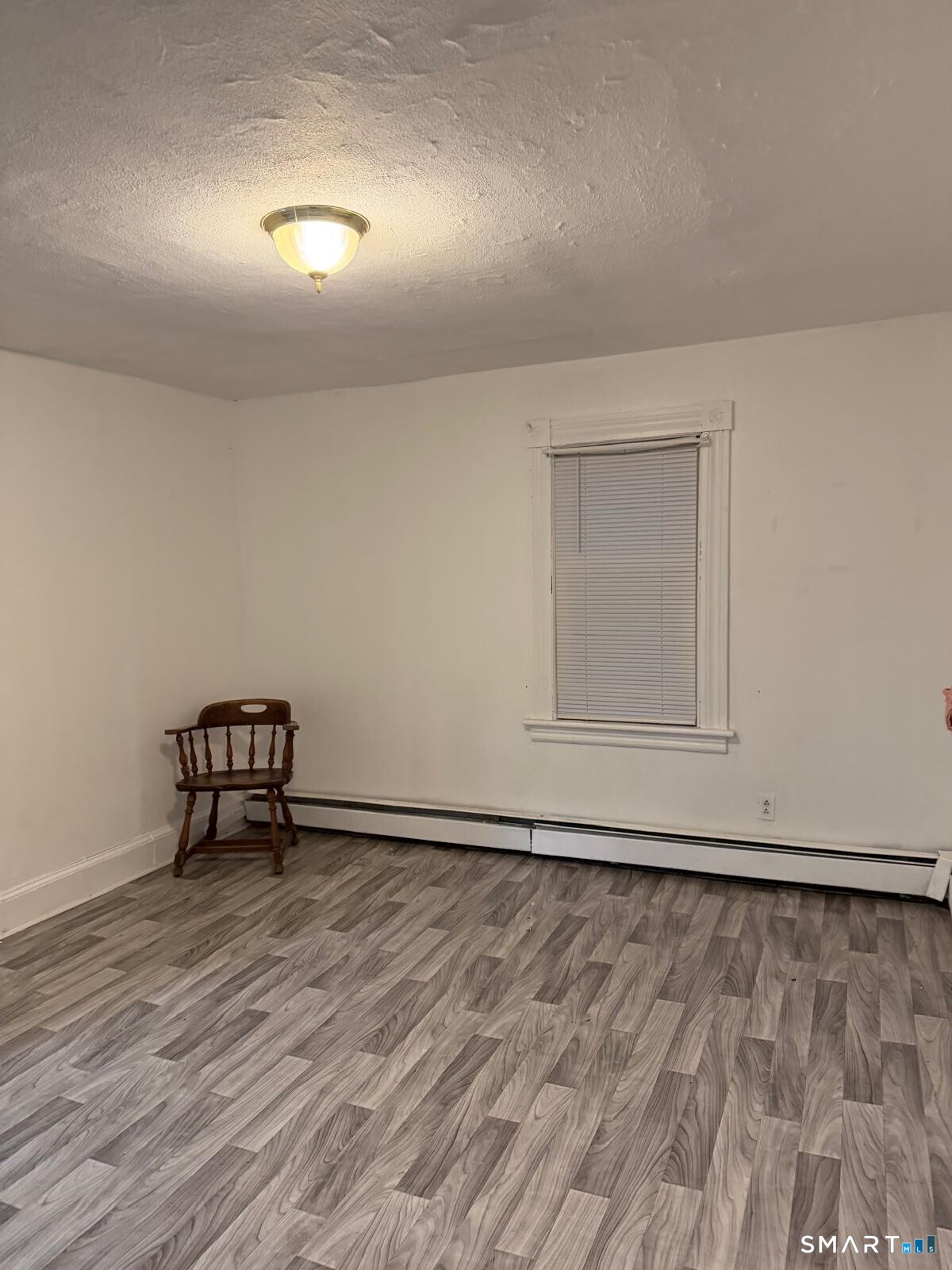27 Connerton Street New Britain, CT 06051 - Photo 16 of 22 a view of an empty room with wooden floor and a window