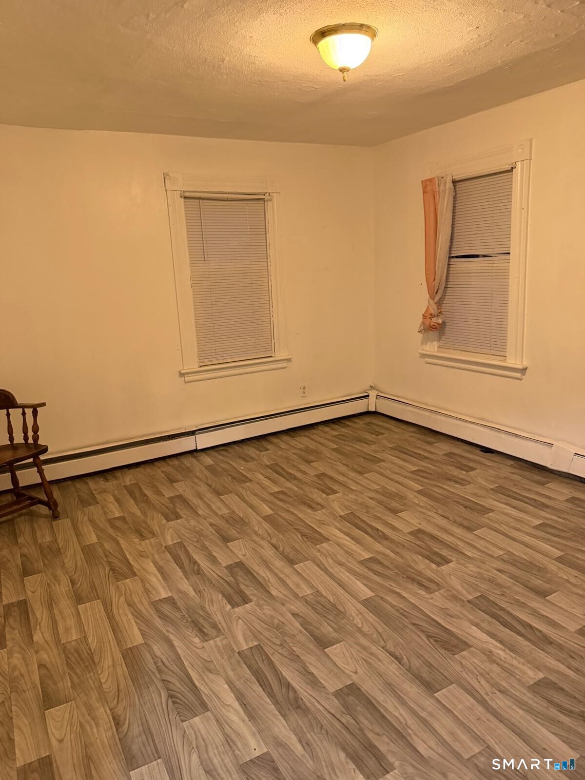 27 Connerton Street New Britain, CT 06051 - Photo 17 of 22 a view of an empty room with wooden floor and cabinet
