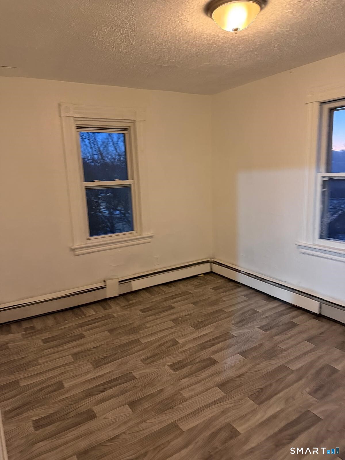27 Connerton Street New Britain, CT 06051 - Photo 18 of 22 an empty room with wooden floor and windows