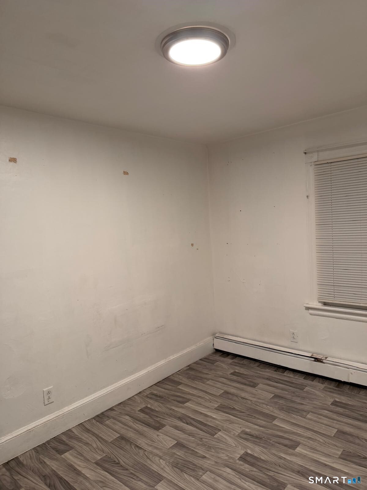 27 Connerton Street New Britain, CT 06051 - Photo 19 of 22 a view of an empty room with wooden floor and a window