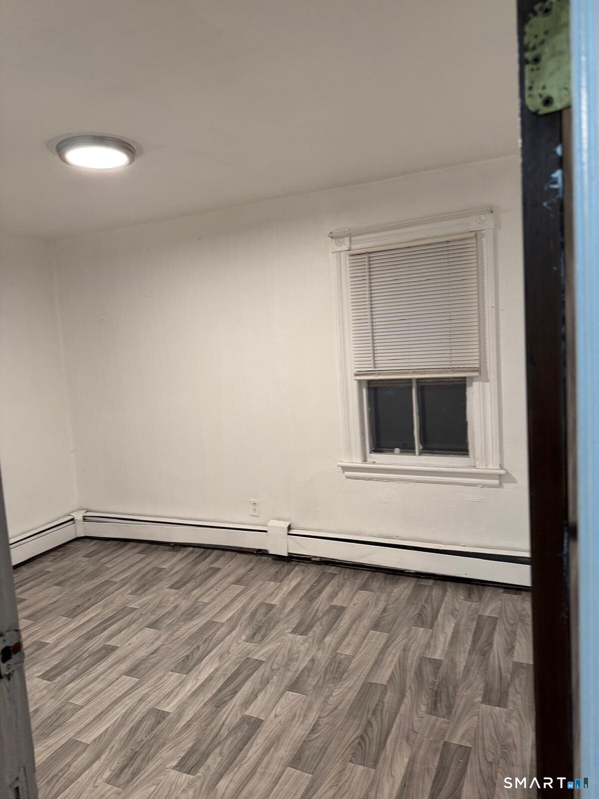 27 Connerton Street New Britain, CT 06051 - Photo 20 of 22 a view of an empty room with wooden floor and a window