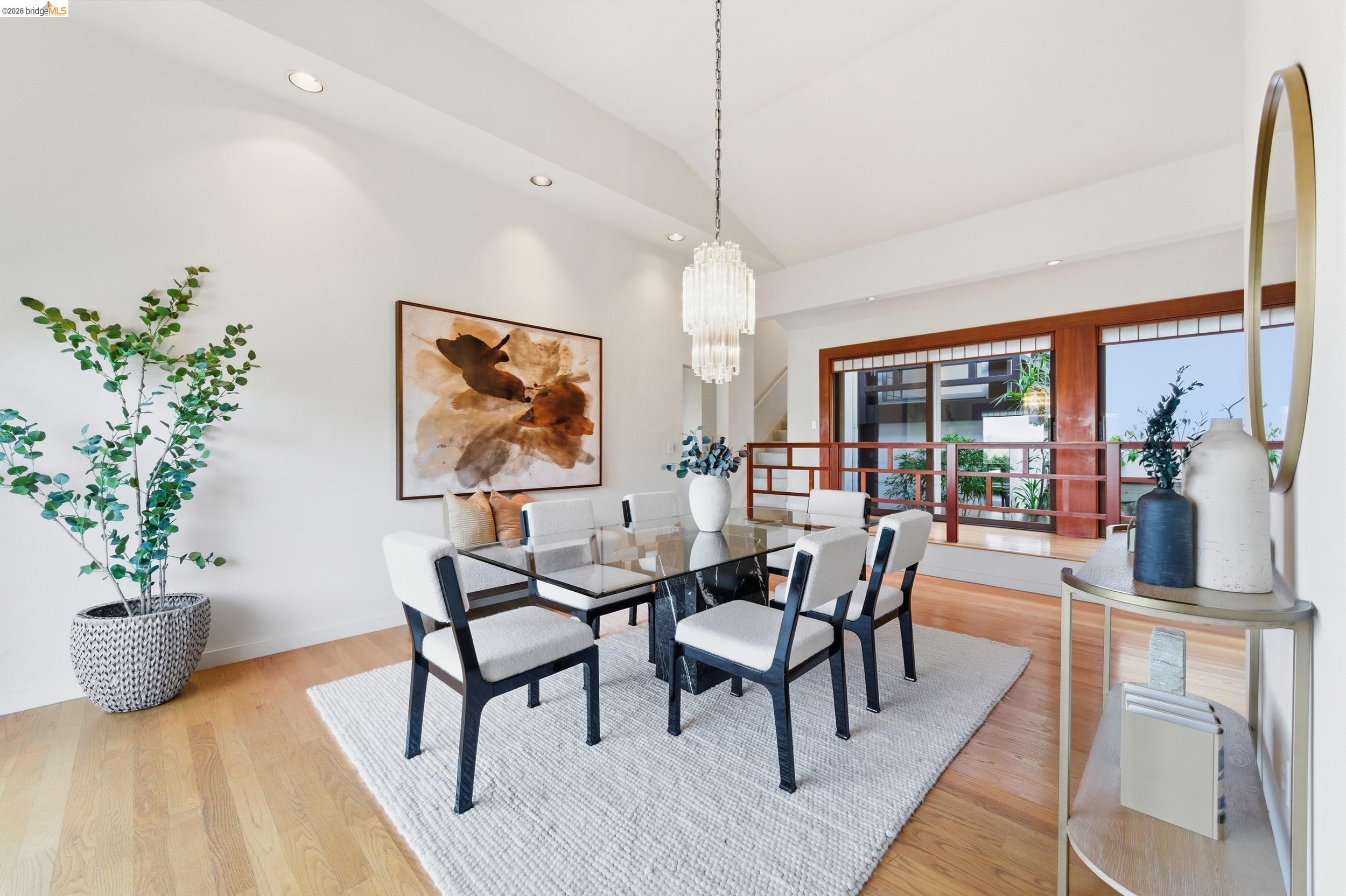 271 Monte Vista Ridge Road Orinda, CA 94563 - Photo 14 of 59 a dining room with furniture potted plants and wooden floor