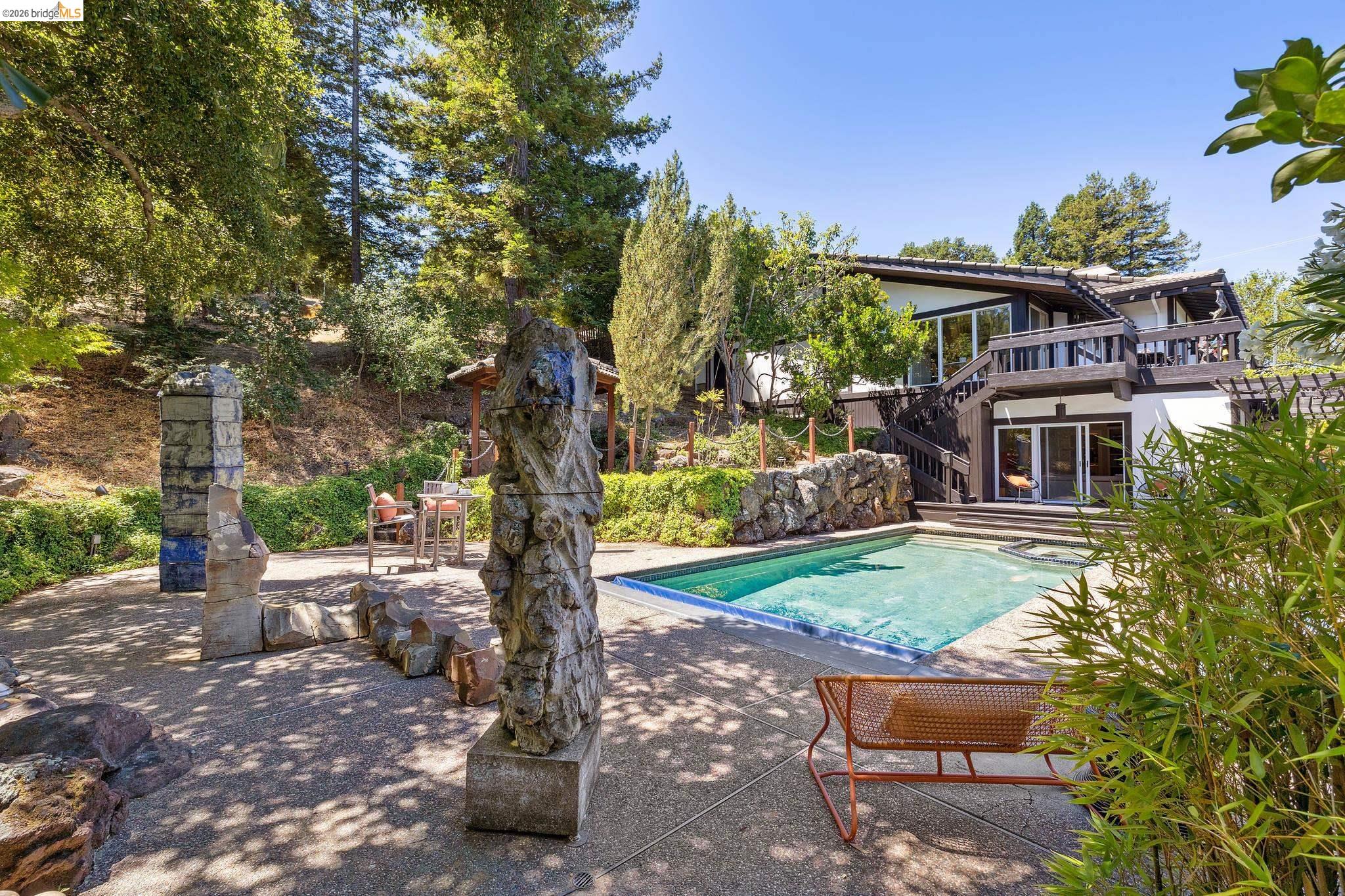 271 Monte Vista Ridge Road Orinda, CA 94563 - Photo 45 of 59 a view of backyard with a table and chairs under an umbrella
