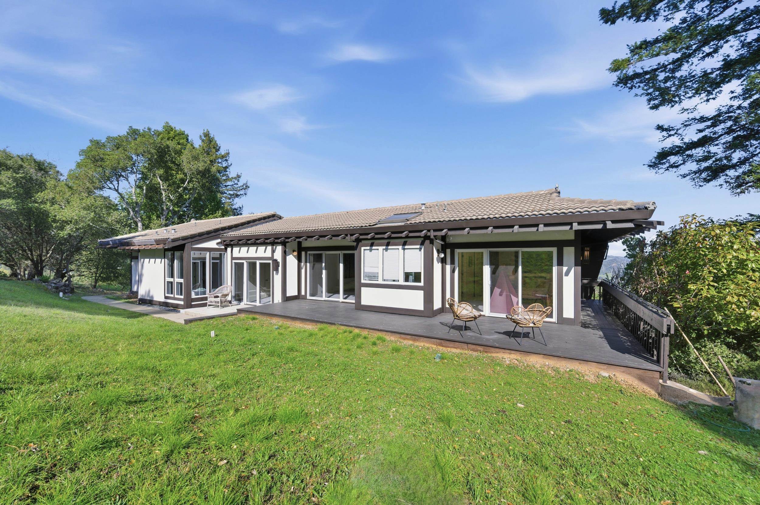 271 Monte Vista Ridge Road Orinda, CA 94563 - Photo 50 of 59 Back of property featuring a yard, a tiled roof, stucco siding, a deck, and roof mounted solar panels