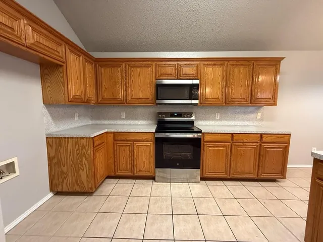 a view of empty room with fan and fireplace