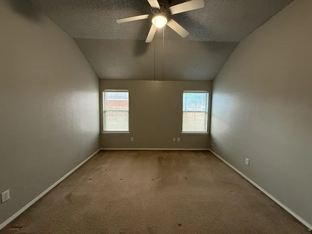 an empty room with windows and closet