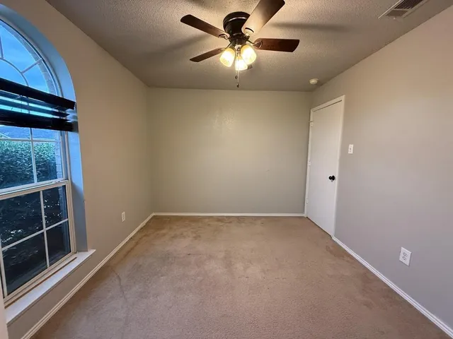 a bathroom with a shower a toilet and a tub