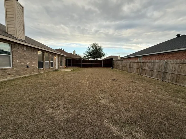 a front view of a house with a garden and yard