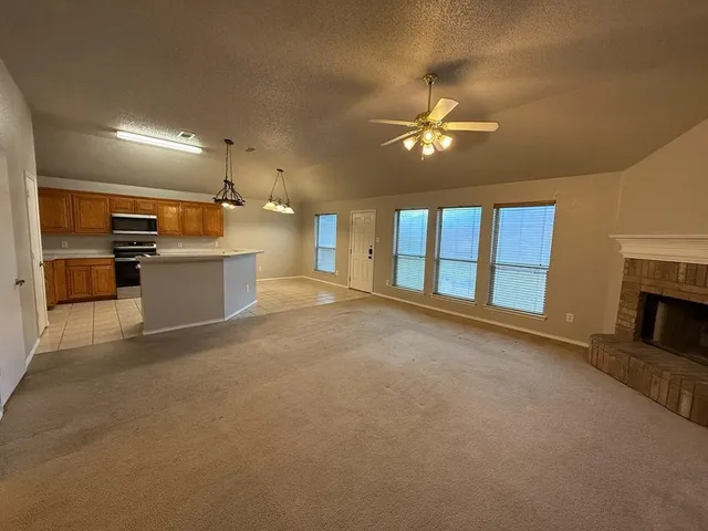 a view of a kitchen with a sink and a fireplace