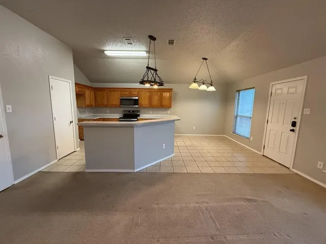 a view of a kitchen with a sink and dishwasher cabinets