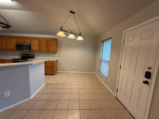 a view of a livingroom with kitchen and furniture