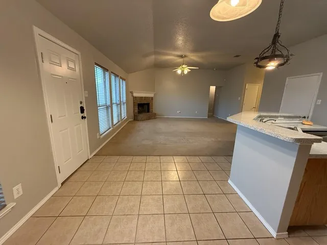 a kitchen with stainless steel appliances granite countertop a sink a stove and a refrigerator