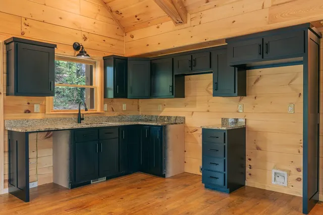 a kitchen with stainless steel appliances granite countertop a stove sink and cabinets