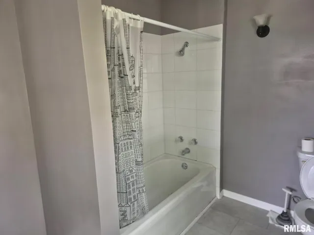 a bathroom with a bathtub and shower