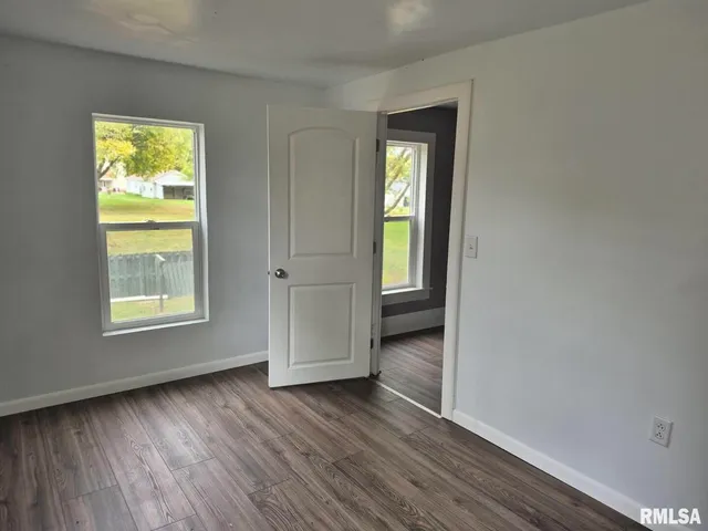 wooden floor in an empty room and a window