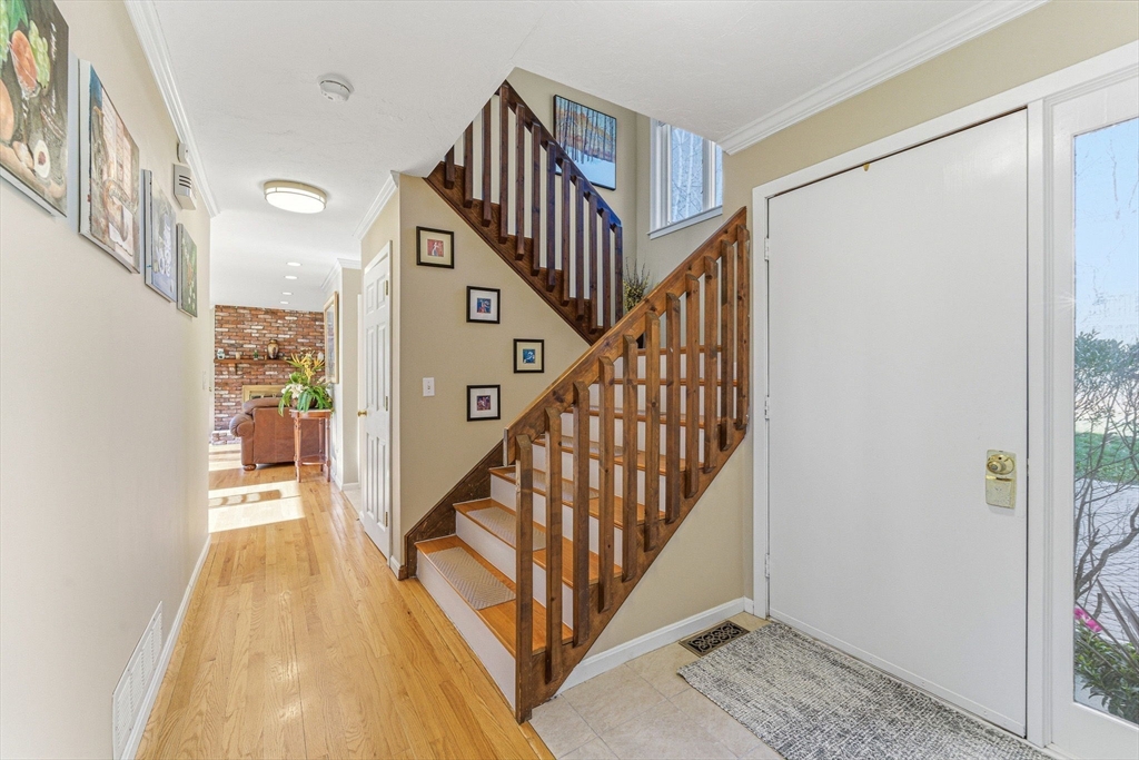 3 Heather Hill Road Acton, MA 01720 - Photo 13 of 33 a view of staircase with lots of frames on wall and wooden floor