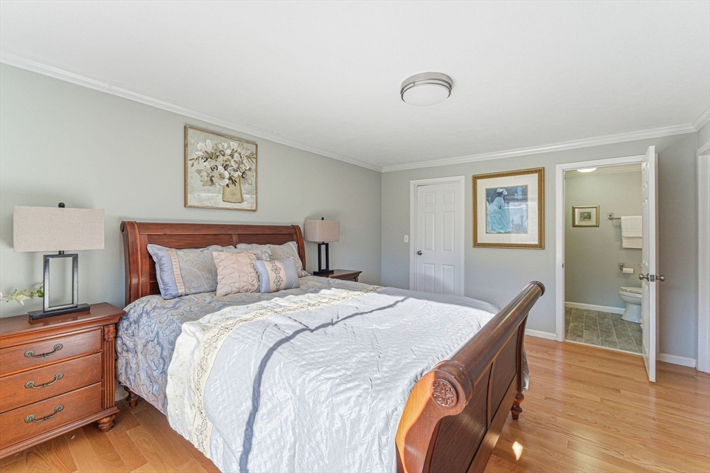 3 Heather Hill Road Acton, MA 01720 - Photo 17 of 33 a spacious bedroom with a bed and a lamp on table