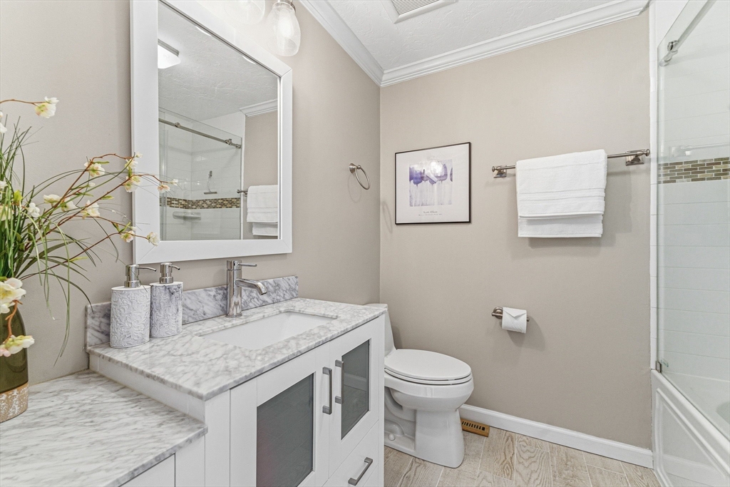 3 Heather Hill Road Acton, MA 01720 - Photo 24 of 33 a bathroom with a granite countertop sink a toilet and a mirror