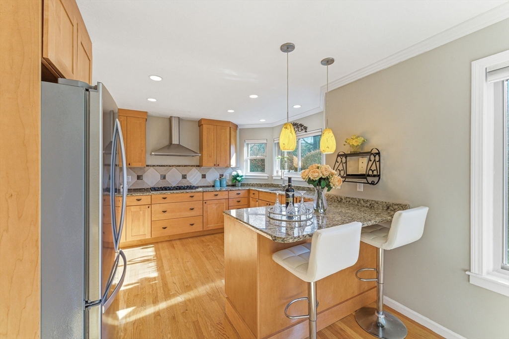 3 Heather Hill Road Acton, MA 01720 - Photo 8 of 33 a kitchen with stainless steel appliances granite countertop a refrigerator a sink a stove and white cabinets