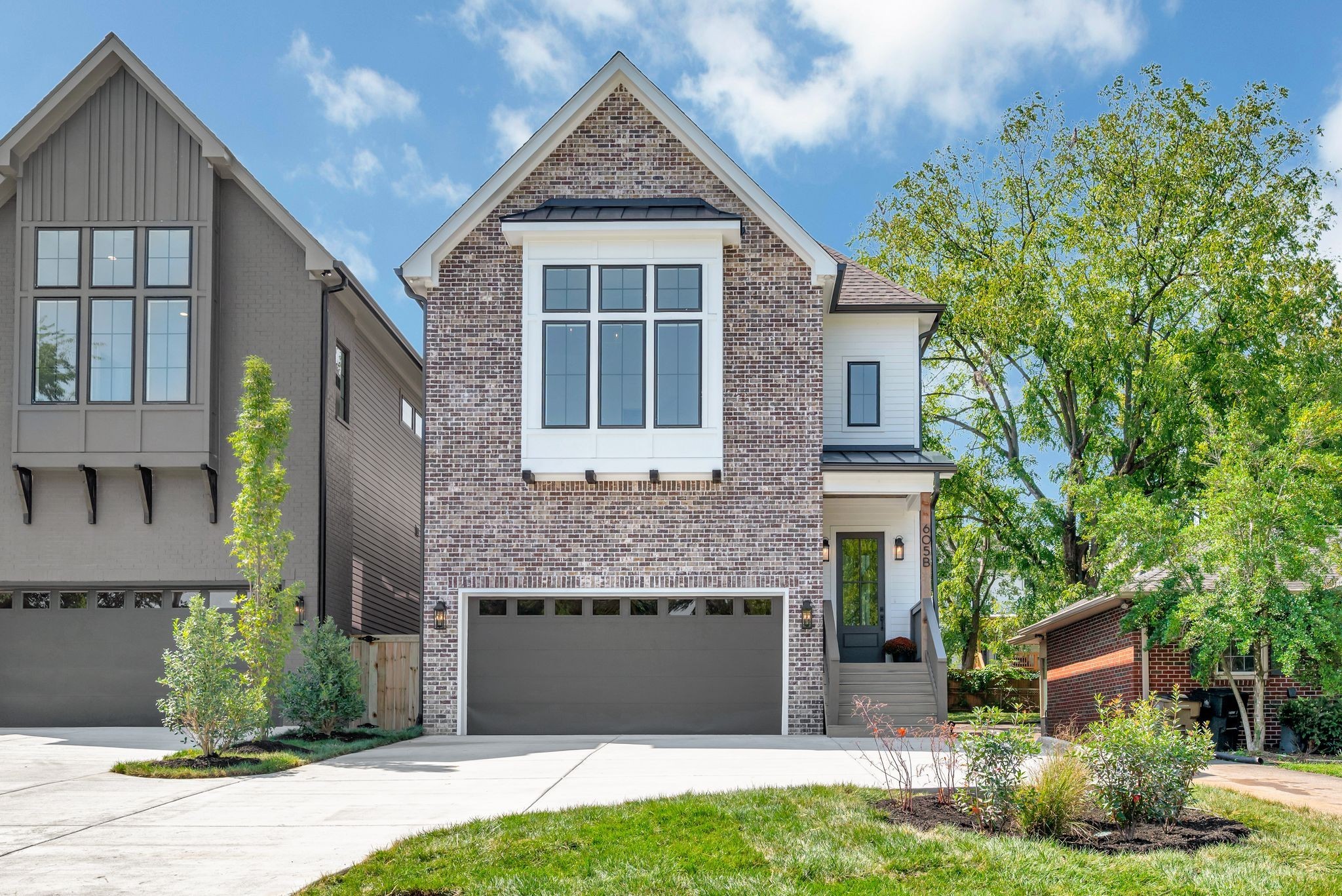 a front view of a house with a garden and plants