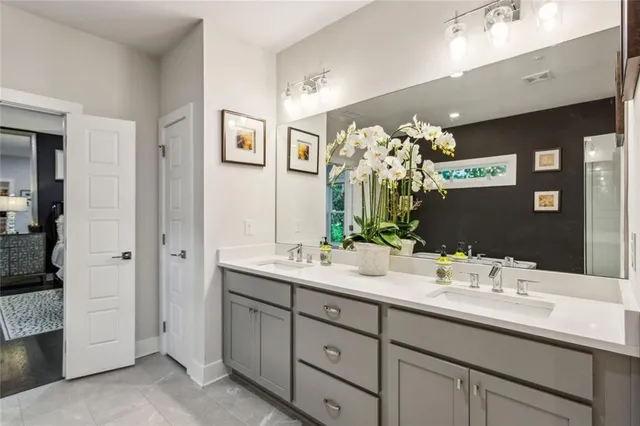a bathroom with a double vanity sink and a mirror