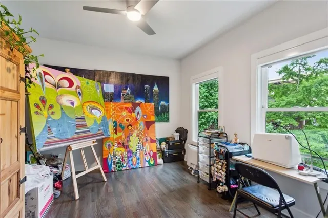 a view of a workspace with furniture and a window