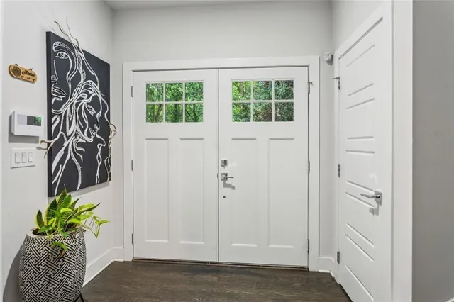 a view of entryway with paintings on the wall