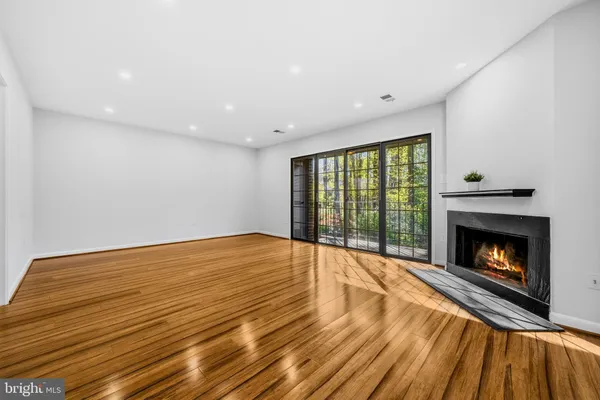 a spacious bedroom with a bed a couch and a large window