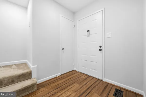a kitchen with stainless steel appliances granite countertop a stove and white cabinets