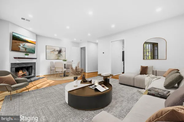a living room with furniture two window and a flat screen tv