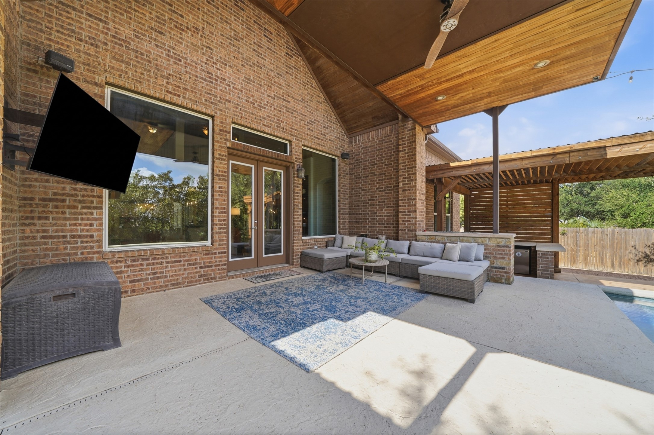 8729 Vantage Point Drive Austin, TX 78737 - Photo 22 of 33 An inviting outdoor living space features a covered patio with a seating area and a refreshing pool.