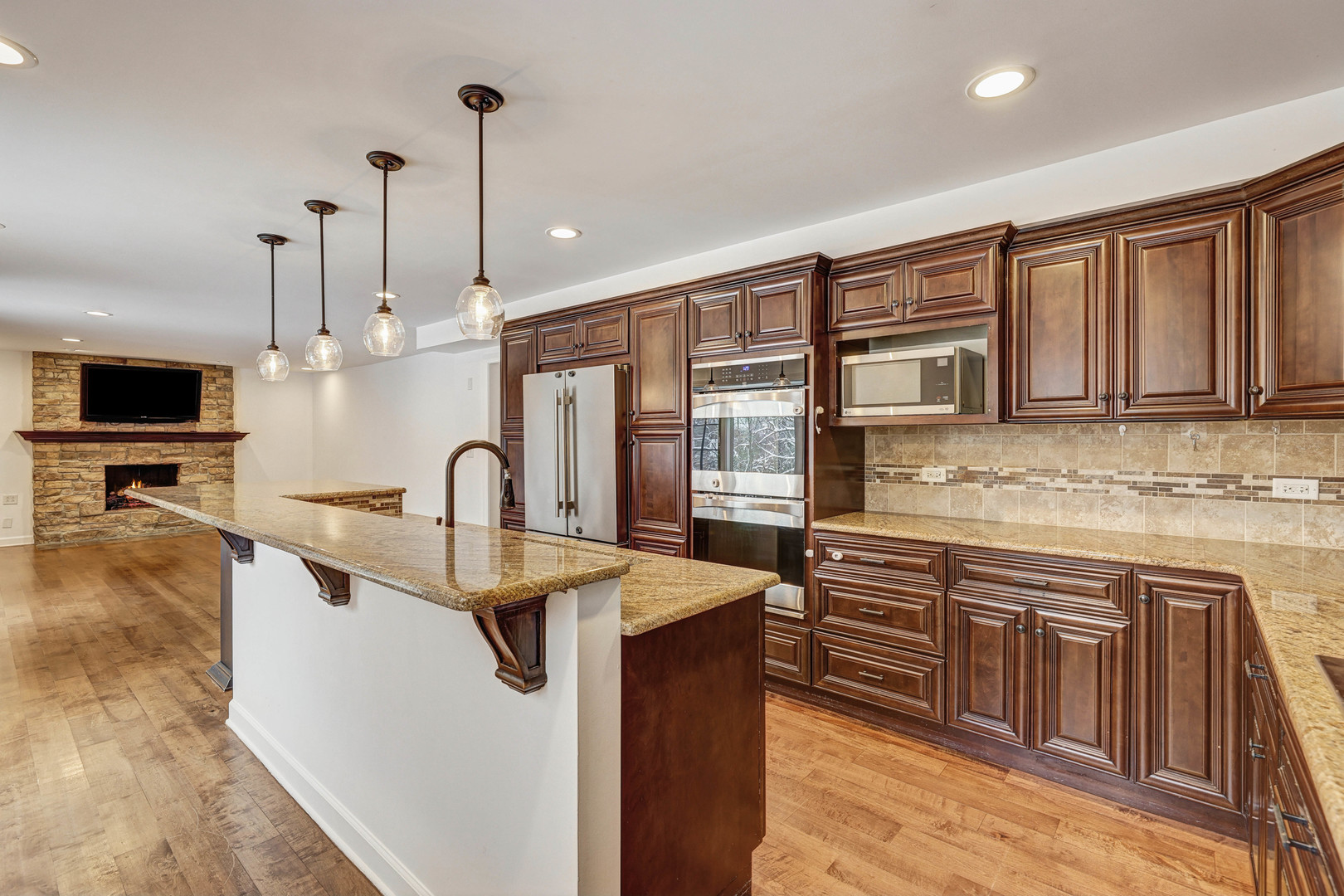 3901 Weathervane Lane Crystal Lake, IL 60012 - Photo 14 of 36 a kitchen with stainless steel appliances granite countertop a sink a stove and a wooden floors