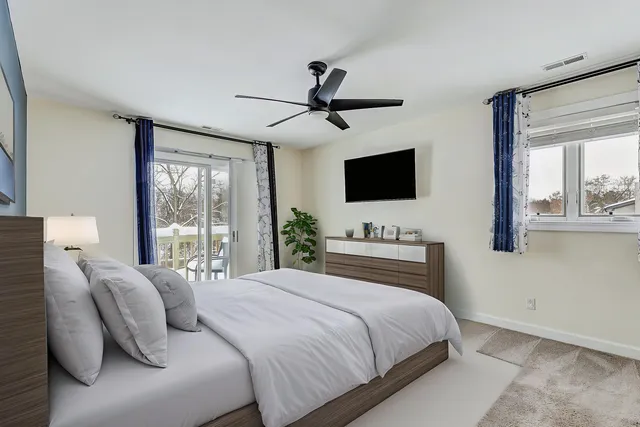 a bedroom with a large bed and a flat screen tv