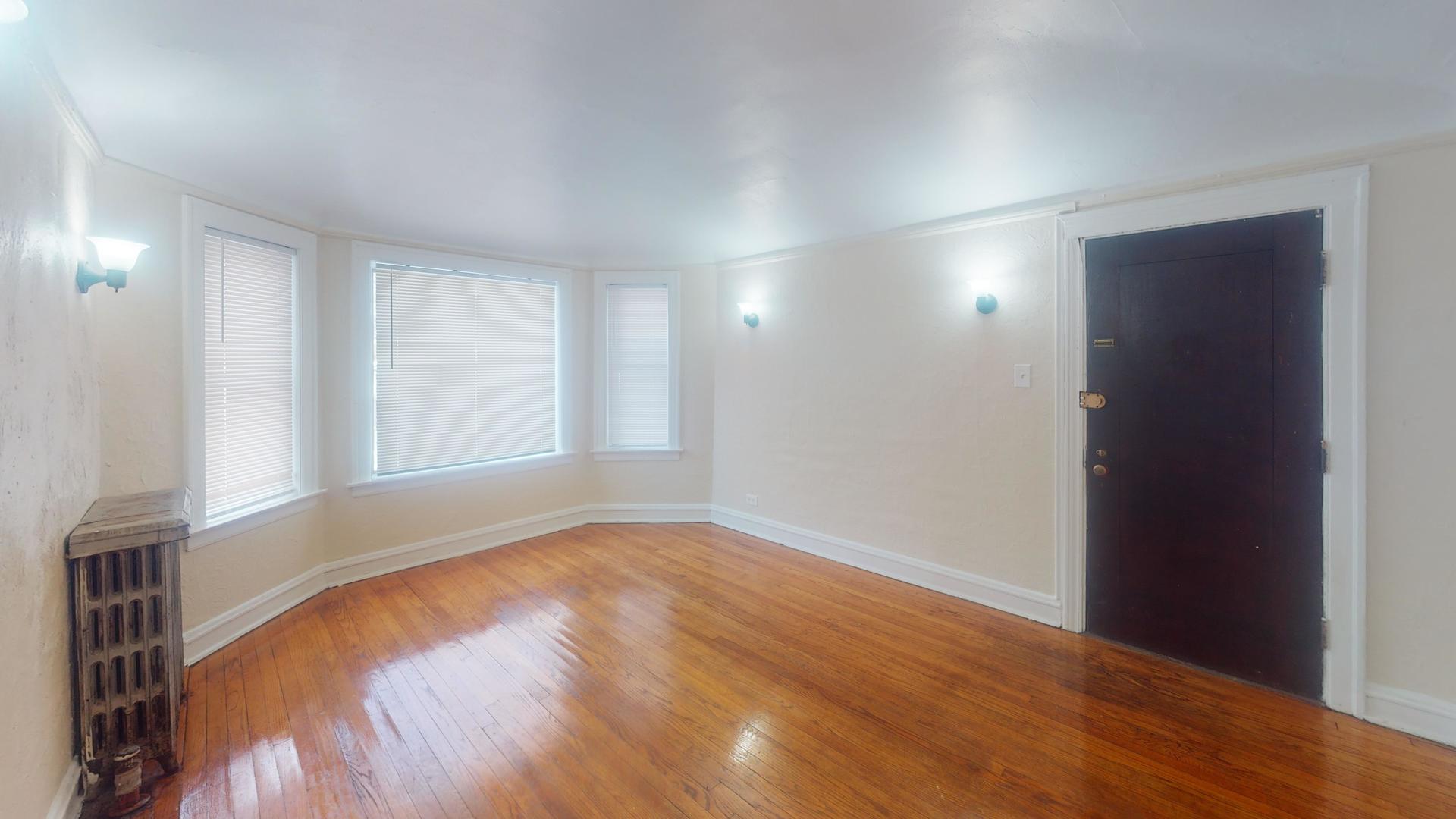621 East 89th Place, Unit 1N Chicago, IL 60619 - Photo 2 of 8 wooden floor in an empty room with a window