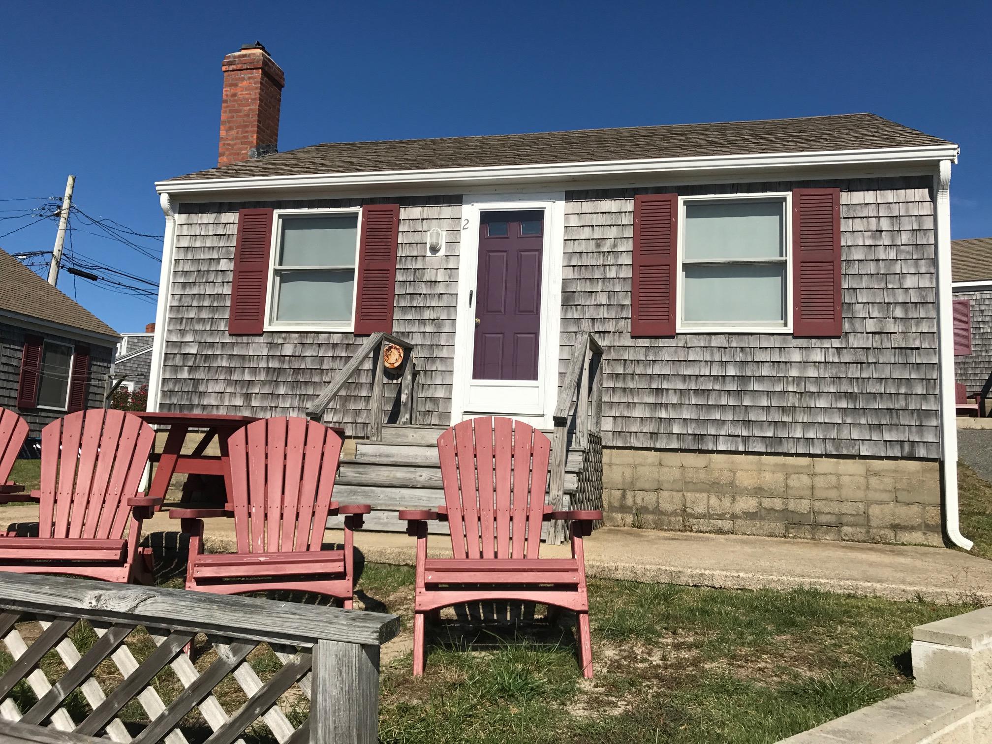 a front view of a house with outdoor seating