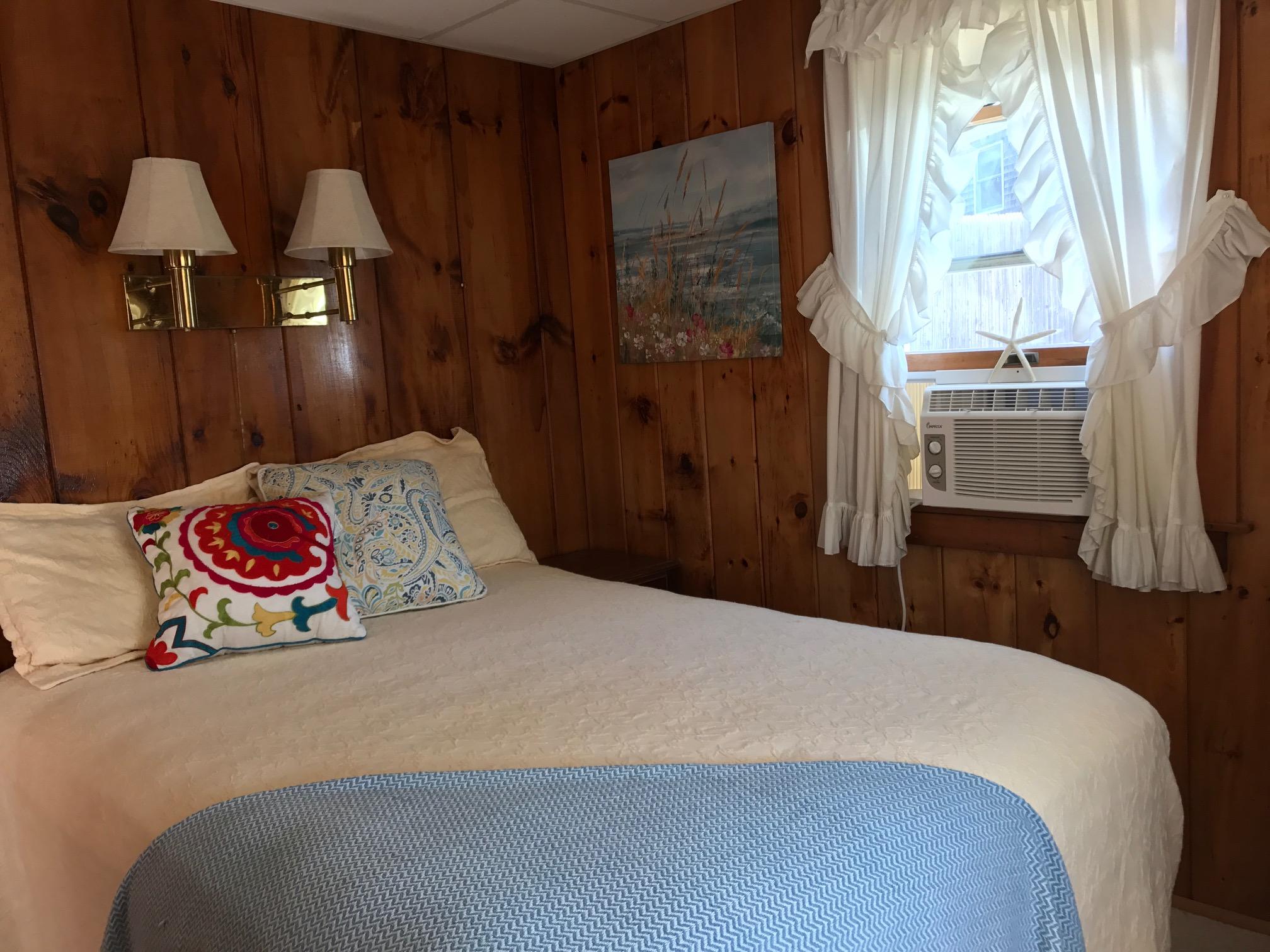 140 Old Wharf Road, Unit 2 Dennis Port, MA 02639 - Photo 11 of 22 a bedroom with a bed and dresser with mirror