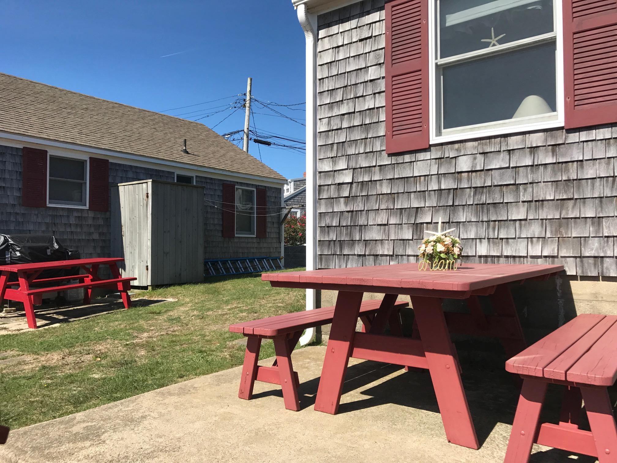 140 Old Wharf Road, Unit 2 Dennis Port, MA 02639 - Photo 16 of 22 a backyard of a house with table and chairs