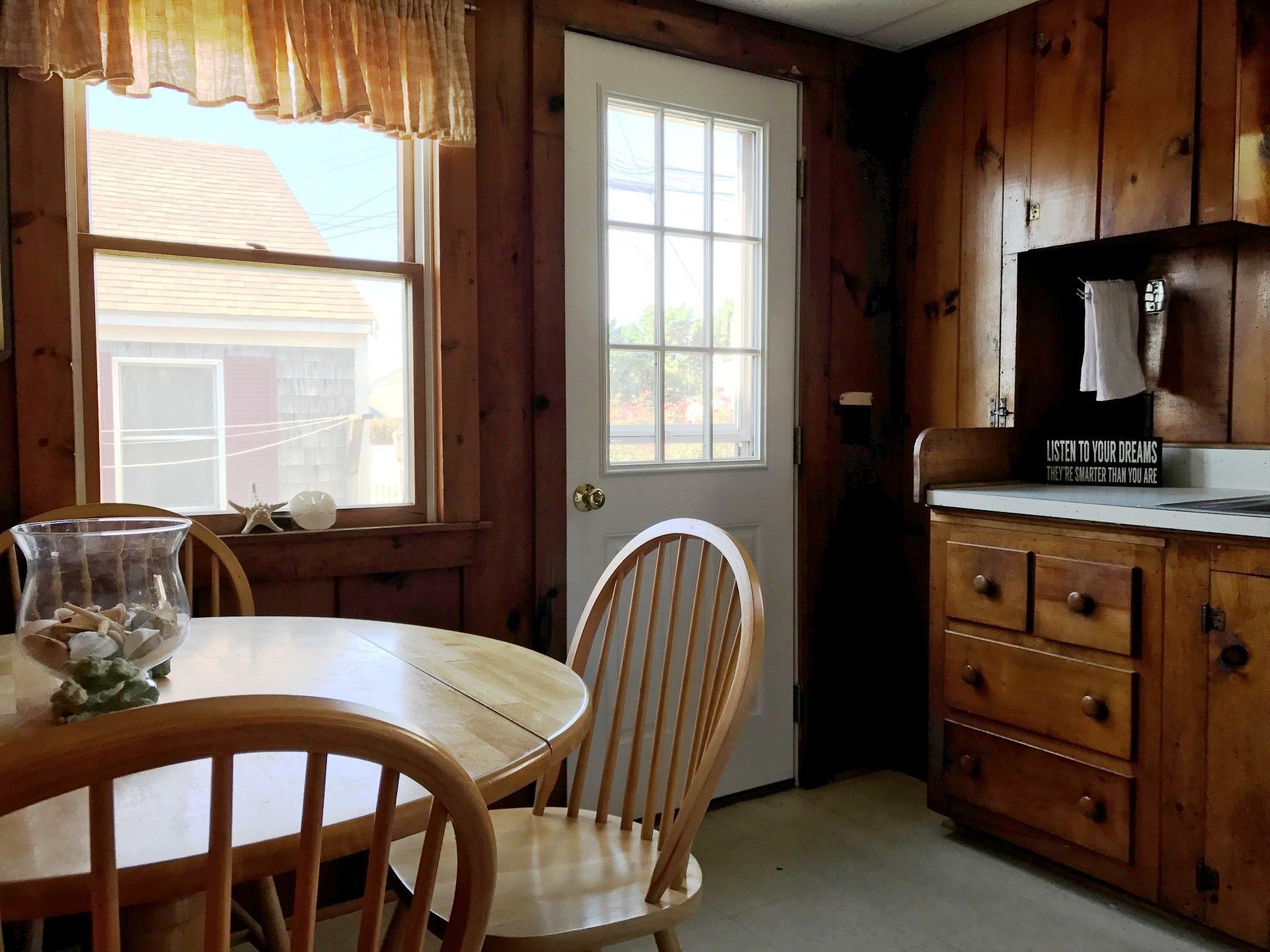 140 Old Wharf Road, Unit 2 Dennis Port, MA 02639 - Photo 7 of 22 a view of a dining room with furniture window and outside view