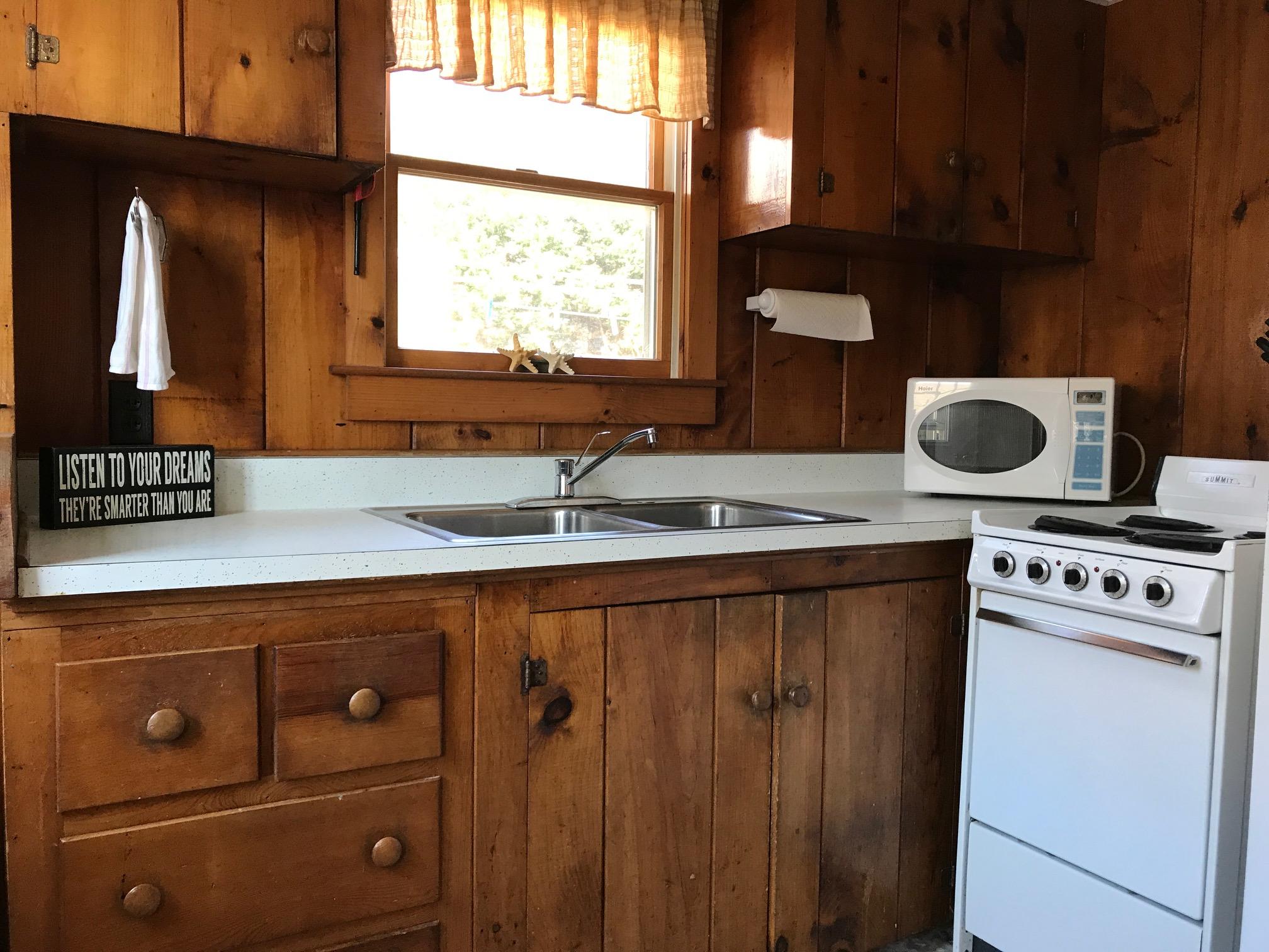 140 Old Wharf Road, Unit 2 Dennis Port, MA 02639 - Photo 9 of 22 a kitchen with a refrigerator and a sink