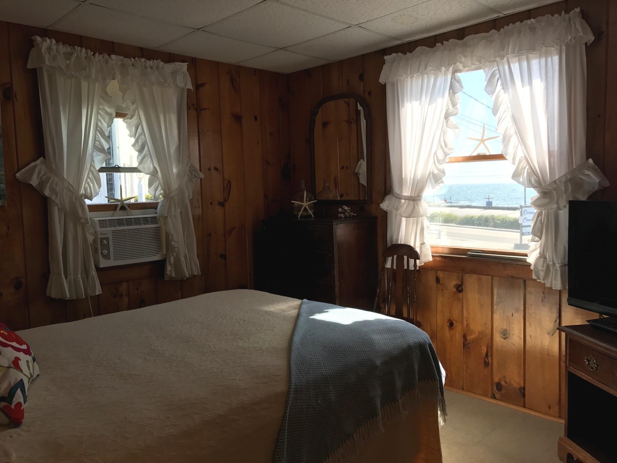140 Old Wharf Road, Unit 2 Dennis Port, MA 02639 - Photo 10 of 22 a bedroom with a bed and a flat tv screen on dresser