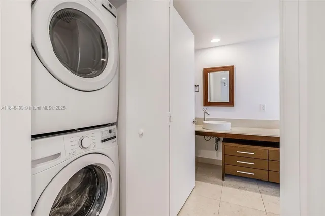 a bathroom with a granite countertop sink a toilet and mirror