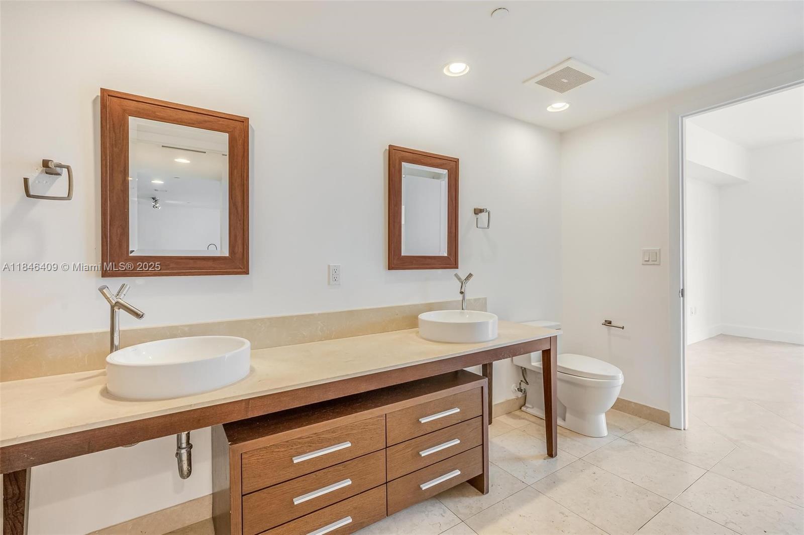 475 Brickell Avenue, Unit 3811 Miami, FL 33131 - Photo 14 of 21 a bathroom with a granite countertop sink a toilet and mirror