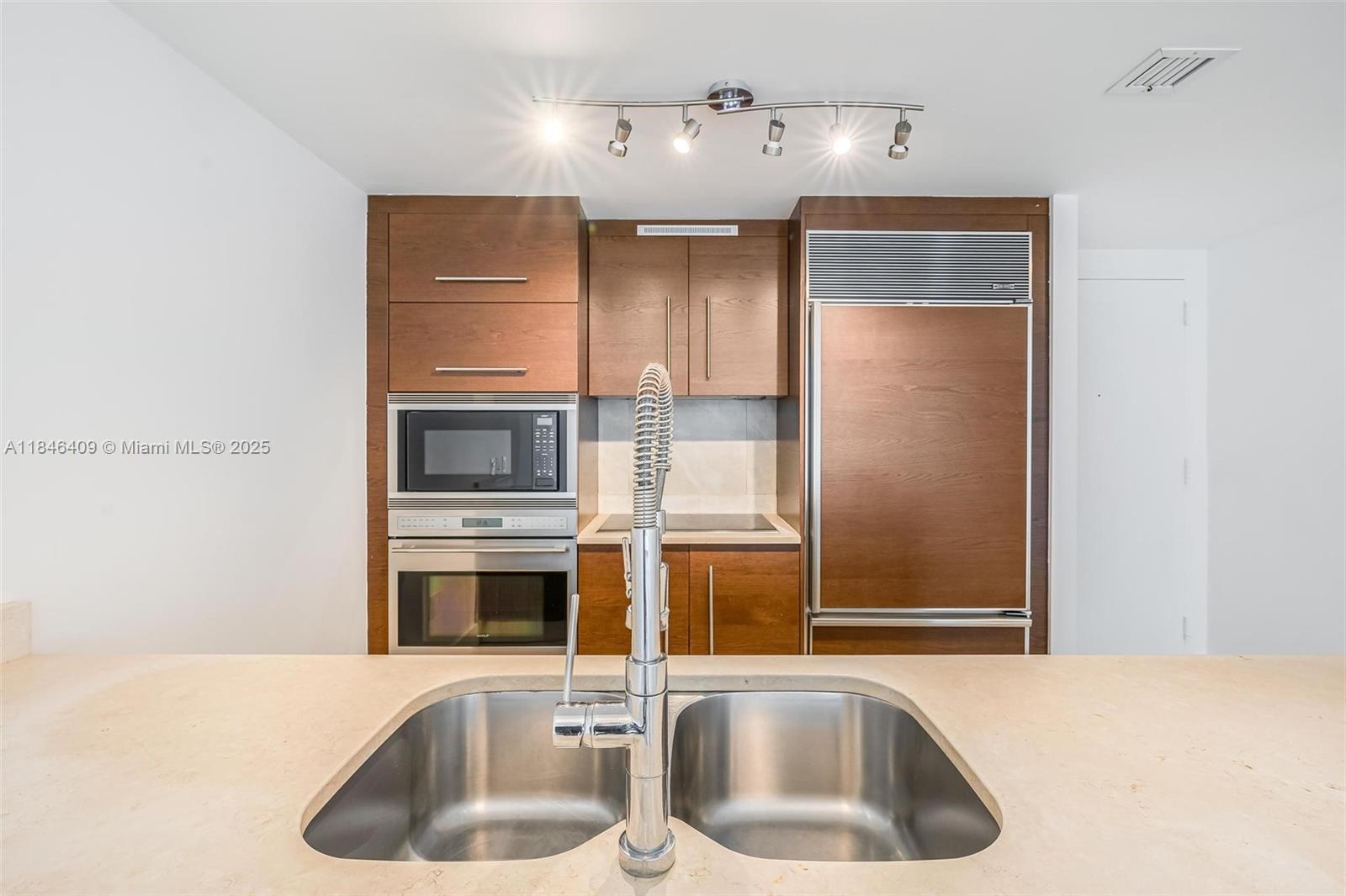 475 Brickell Avenue, Unit 3811 Miami, FL 33131 - Photo 10 of 21 a kitchen with a sink and a microwave